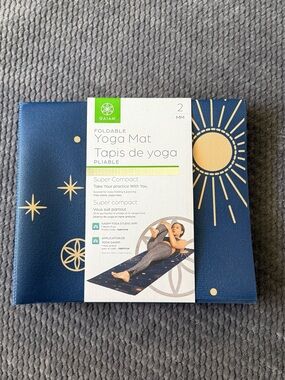 GAIAM Foldable Yoga Mat in Navy with Gold Celestial Design